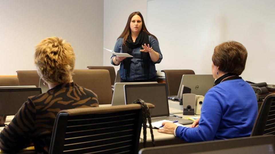 A member of the HR team talks to two adult women