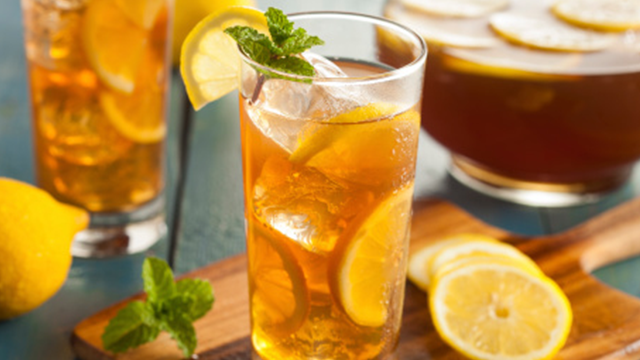 A glass of iced tea garnished with a lemon slice