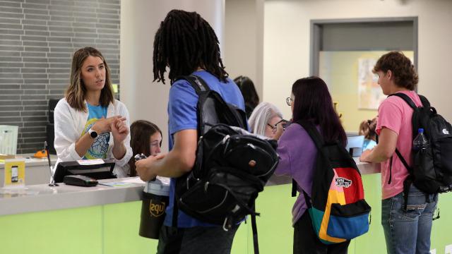 Students speaking to helpful people at the Student Engagement Desk