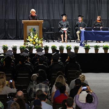 Speaker and crowd at GED graduation ceremony.